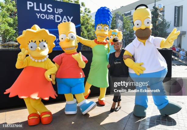 Lisa Simpson, Bart Simpson, Marge Simpson, Maggie Simpson, Yvette Nicole Brown, and Homer Simpson pose for portrait at the Disney+ Official U.S....