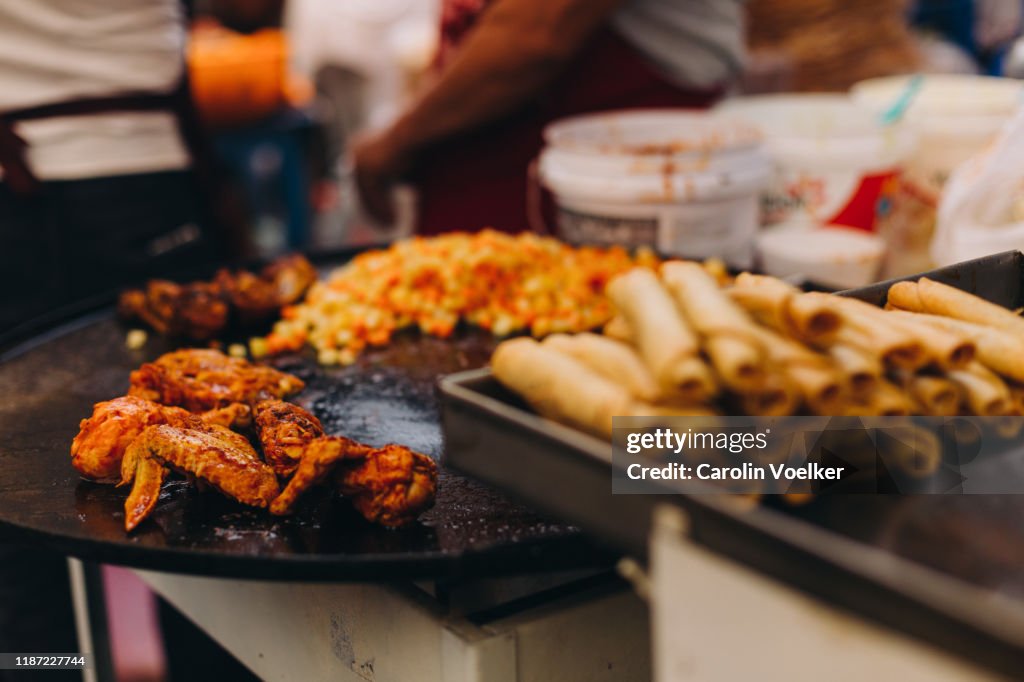Spicy chicken legs frying and being sold at the Day of the Dead fair in Capula, Mexico