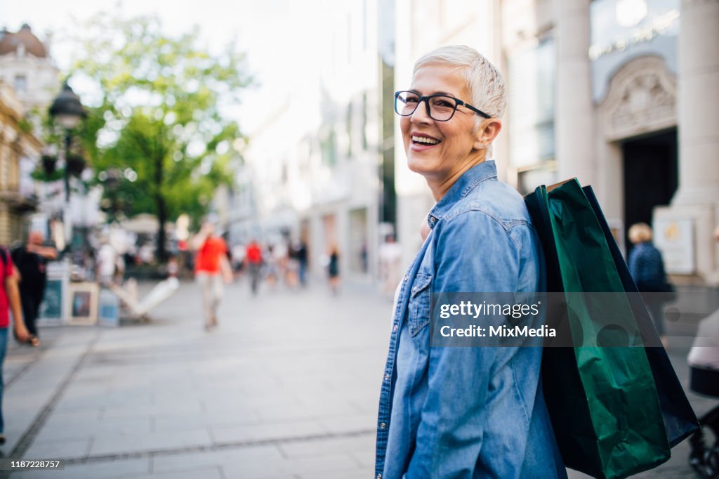 Senior lady shopping in city shops