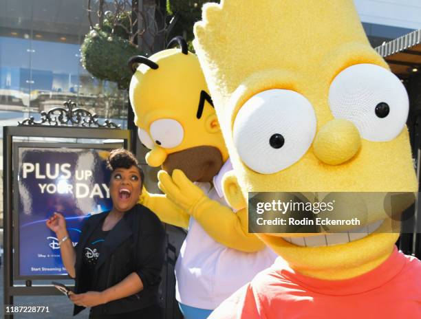 Yvette Nicole Brown and Homer Simpson get photobombed by Bart Simpson at the Disney+ Official U.S. Launch Party at The Grove at The Grove on November...
