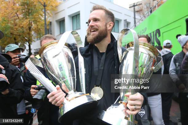 Stefan Frei of the Seattle Sounders holds his MLS Cup trophies from 2016 and 2019 during their MLS Cup victory parade on November 12, 2019 in...