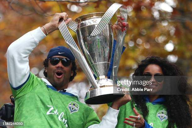 Seattle Sounders part owners Russell Wilson and Ciara show their support for the team during their MLS Cup victory parade on November 12, 2019 in...