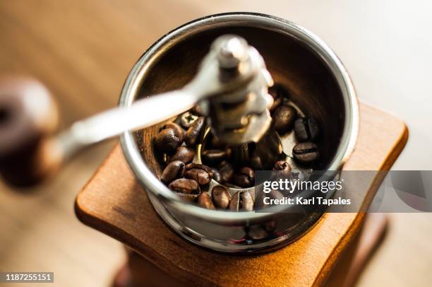 roasted coffee beans on a old-fashioned coffee grinder - 挽く ストックフォトと画像
