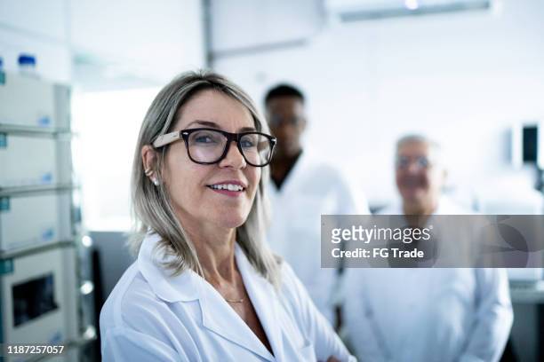portrait of smiling scientist looking at camera - doctor partnership stock pictures, royalty-free photos & images