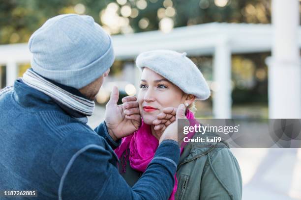 affectionate hispanic couple look into each other's eyes - staring stock pictures, royalty-free photos & images