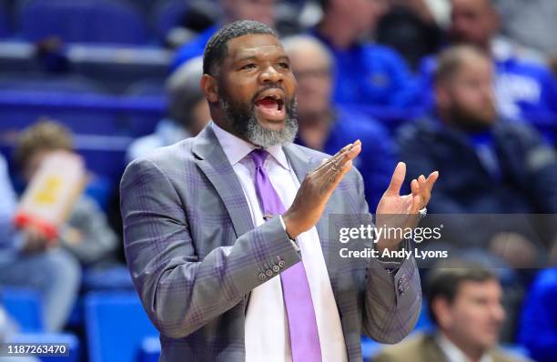 Walter McCarty the head coach of the Evansville Aces gives instructions to his team in the 67-64 win over the Kentucky Wildcats at Rupp Arena on...