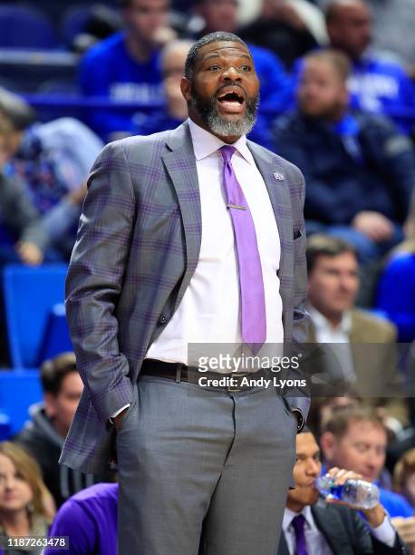 Walter McCarty the head coach of the Evansville Aces gives instructions to his team in the 67-64 win over the Kentucky Wildcats at Rupp Arena on...