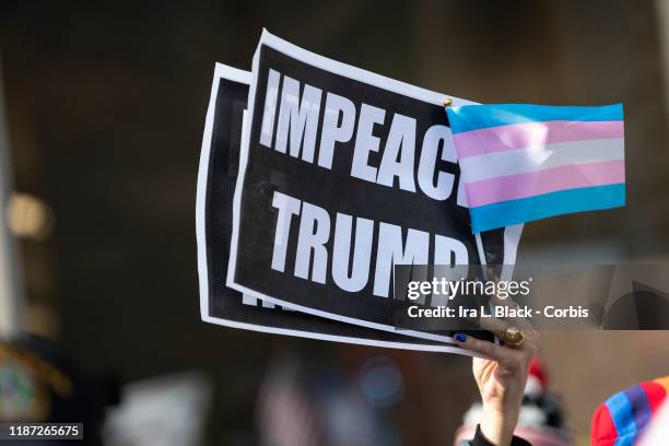 Protesters that support gay and transgender rights outside on 5th Avenue with signs that say "IMPEACH TRUMP" with a Pride flag after the 45th...