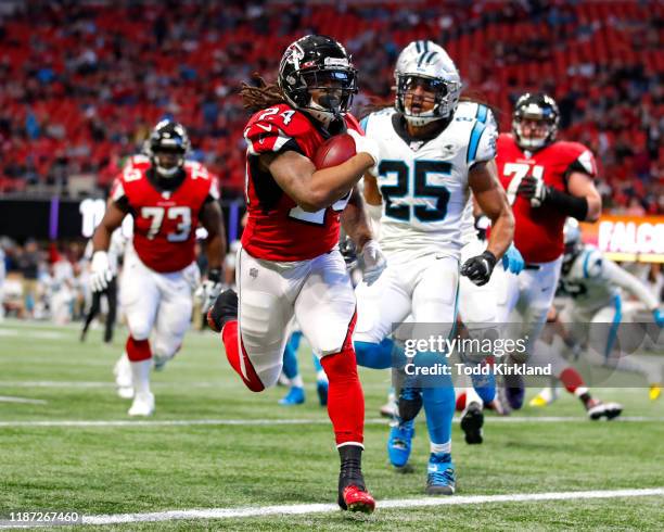 Devonta Freeman of the Atlanta Falcons rushes in for a touchdown in the second half on an NFL game against the Carolina Panthers at Mercedes-Benz...