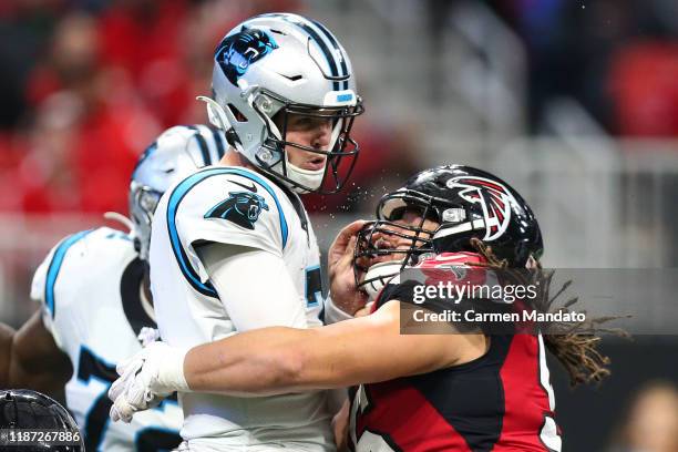 Kyle Allen of the Carolina Panthers is hit by Tyeler Davison of the Atlanta Falcons during the second half of the game at Mercedes-Benz Stadium on...