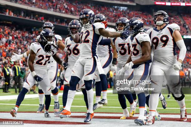 Kareem Jackson of the Denver Broncos celebrates with temmates after an interception in the fourth quarter against the Houston Texans at NRG Stadium...
