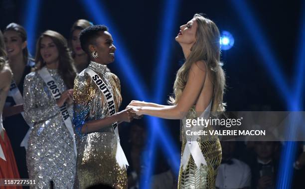 Miss South Africa Zozibini Tunzi and Miss Puerto Rico Madison Anderson , the two finalists, wait to hear the winner's name on stage during the 2019...