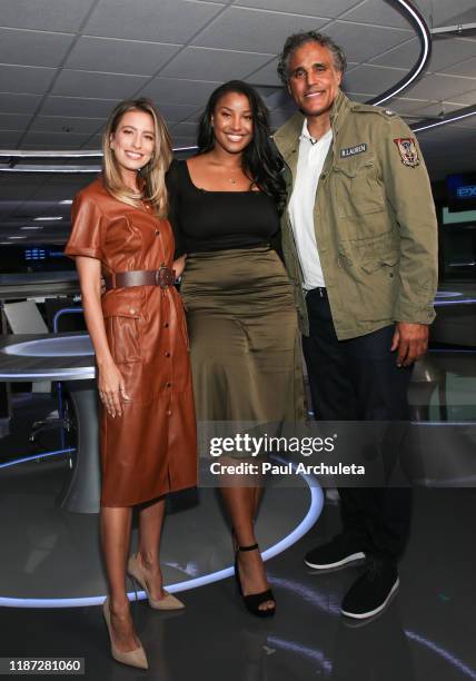 Renee Bargh, Sasha Gabriella Fox and Rick Fox on the set of "Extra" at Burbank Studios on November 12, 2019 in Burbank, California.