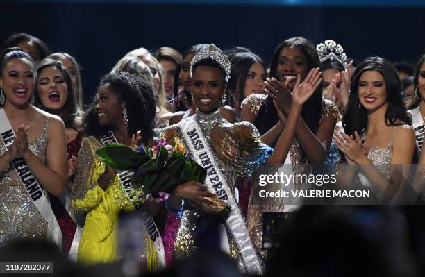 Newly crowned Miss Universe 2019 South Africa's Zozibini Tunzi waves from stage after the 2019 Miss Universe pageant at the Tyler Perry Studios in...