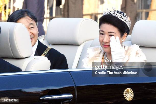 Empress Masako wipes her tears while Emperor Naruhito waves from their car during the imperial parade for enthronement of Emperor Naruhito on...