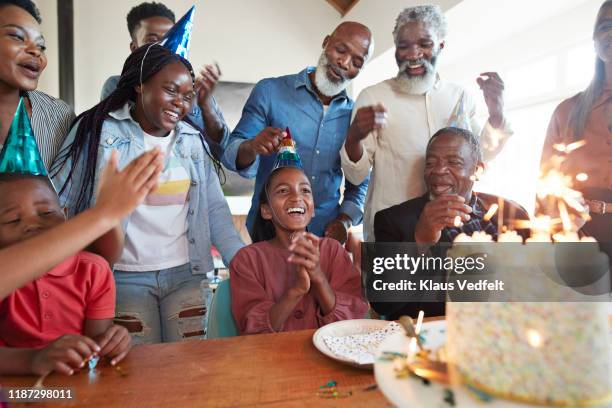 family applauding for girl during birthday celebration - older woman birthday stock pictures, royalty-free photos & images