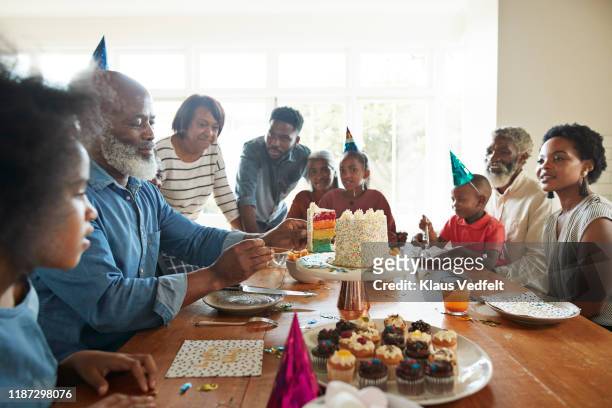 family celebrating birthday together at home - lob wedge stock-fotos und bilder