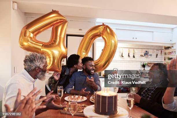 happy family enjoying birthday celebration - wife birthday stock pictures, royalty-free photos & images