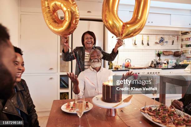 female with number 60 balloons at birthday party - milestone stockfoto's en -beelden