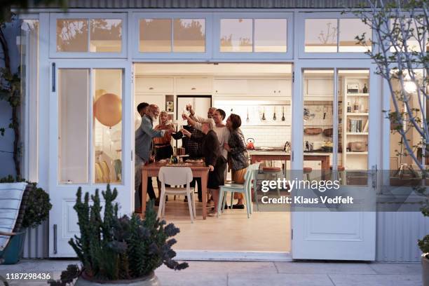 cheerful family toasting drinks during birthday party - family house ストックフォトと画像