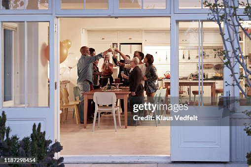 Family toasting drinks during birthday party Family toasting drinks during birthday party