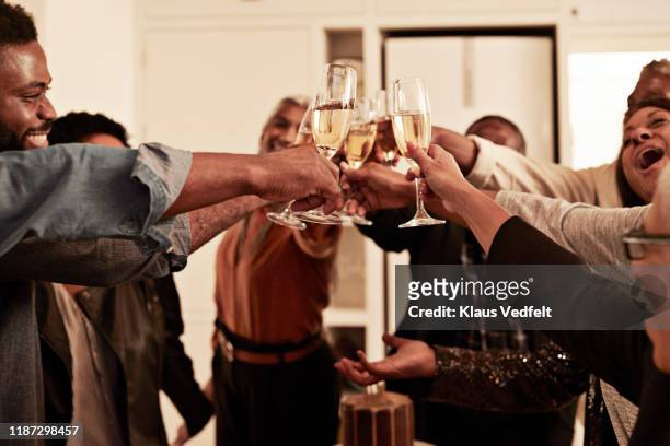 cheerful family enjoying drinks at birthday party - champagne toast stock-fotos und bilder