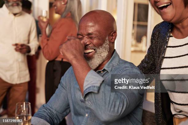 cheerful man and woman enjoying party - black people laughing stock-fotos und bilder