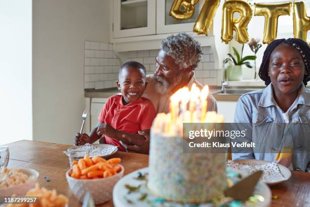 family at home during birthday party - series 4 3 stockfoto's en -beelden