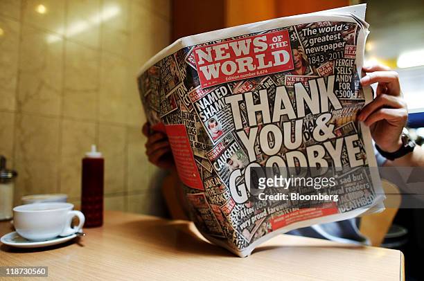 Man reads the last issue of the News of the World, published by Rupert Murdoch's News Corp., at a cafe in London, U.K., on Sunday, July 10, 2011. The...