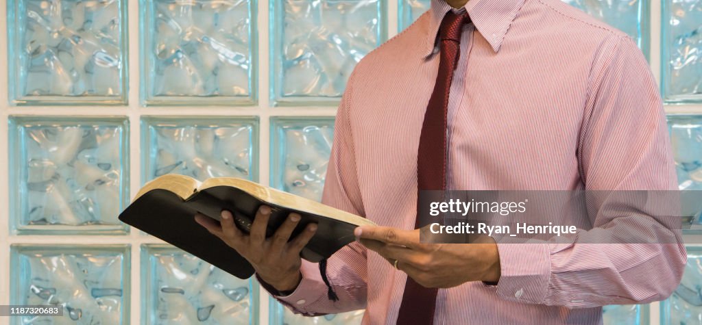 Men reading and holding the Holy Bible