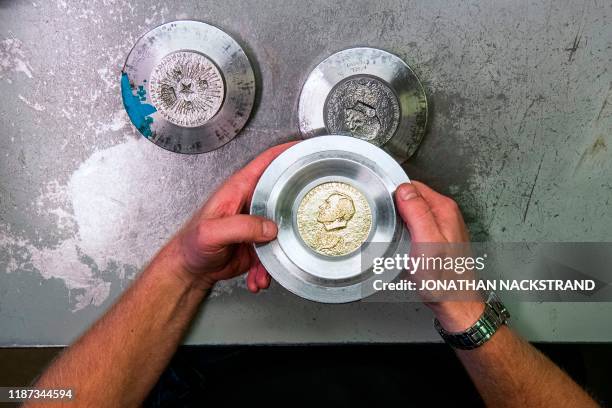 Niklas Qvarnstrom, a craftsman in charge of the Nobel Prize medals, works during the production of the medals on October 29, 2019 in Eskilstuna,...