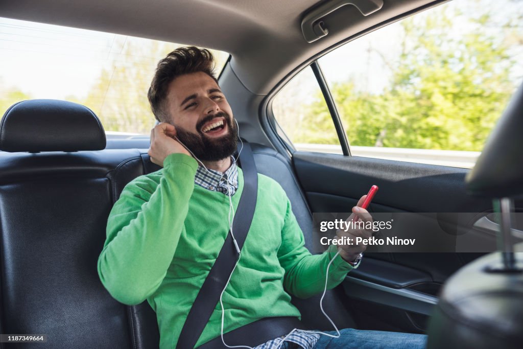 Man listening to music and singing in the car