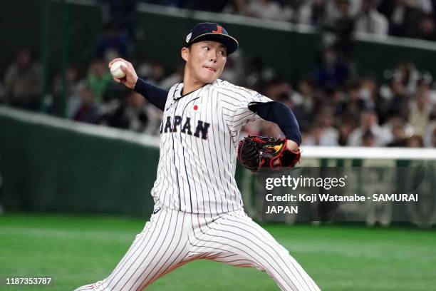 Pitcher Yoshinobu Yamamoto throws in the top of 8th inning during the WBSC Premier 12 Super Round game between Japan and Mexico at the Tokyo Dome on...