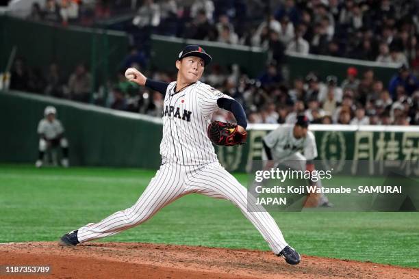 Pitcher Yoshinobu Yamamoto throws in the top of 8th inning during the WBSC Premier 12 Super Round game between Japan and Mexico at the Tokyo Dome on...