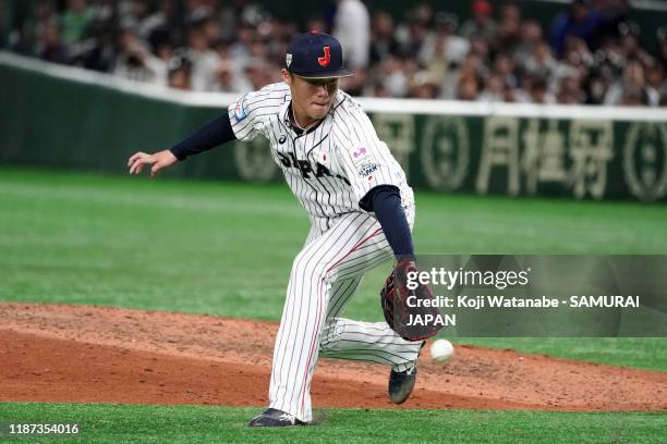 Pitcher Yoshinobu Yamamoto of Japan makes a fielding error in the top of 8th inning during the WBSC Premier 12 Super Round game between Japan and...