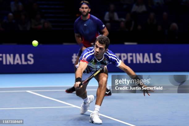 Jean-Julien Rojer of The Netherlands, playing partner of Horia Tecau of Romania plays a backhand in their doubles match against Juan Sebastian Cabal...