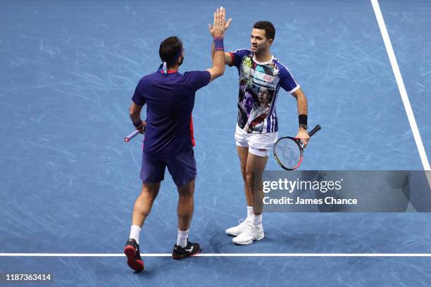 Jean-Julien Rojer of The Netherlands and Horia Tecau of Romania celebrate match point in their doubles match against Juan Sebastian Cabal and Robert...