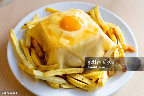 traditional portuguese cuisine, francesinha sandwich - porto portugal food stock pictures, royalty-free photos & images