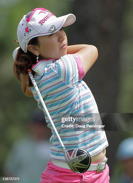 Mika Miyazato of Japan follows through on her tee shot on the 11th hole during the continuation of the third round of the U.S. Women's Open at The...