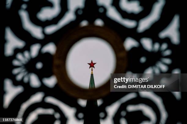 View of a ruby star atop one of the Kremlin's towers in downtown Moscow on December 9, 2019. - Russia will miss next year's Tokyo Olympics and the...