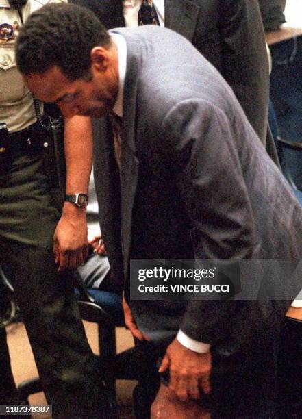 Murder defendant O.J. Simpson shows the jury, 25 January 1995 in Los Angeles, a surgery scar on his left knee, injured during his career as a...