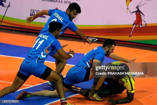 India's players tussle with Sri Lanka's D.D.G Madushanka during the Kabaddi final at the 13th South Asian Games in Kathmandu on December 9, 2019.