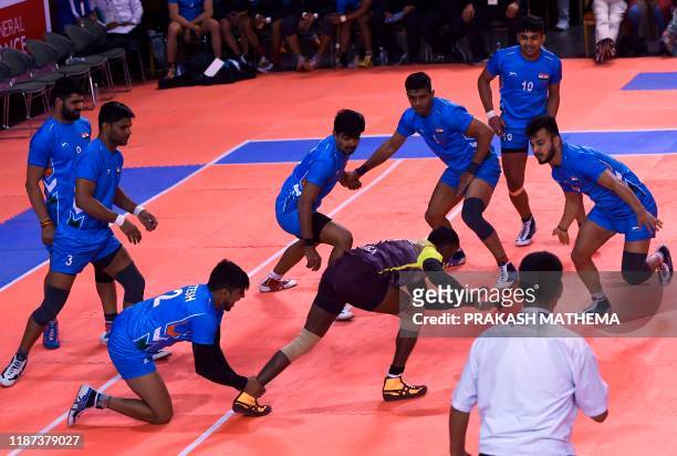 India's players tussle with Sri Lanka's Rathnayake during the Kabaddi final at the 13th South Asian Games in Kathmandu on December 9, 2019.