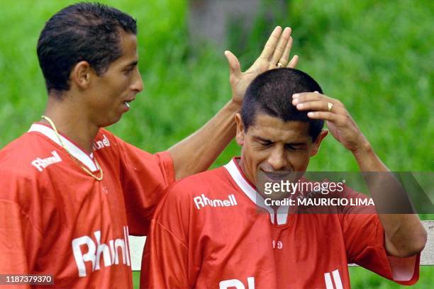 Cesar who has a proposal to paly in Spanish soccer club Real Madrid, and Adhemar Ferreira, both players of Sao Caetano, joke during a practice...