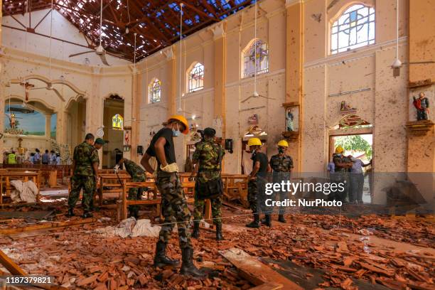 Sri Lankan military officers conduct inspections inside the St. Sebastians church where a bomb blast took place in the town of Negombo, 30kms off...