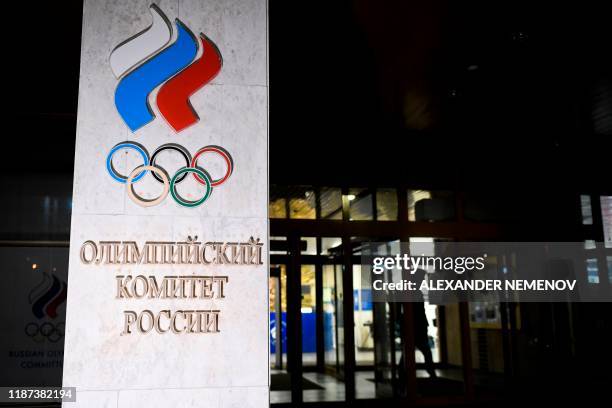 Person walks out of the Russian Olympic Committee headquarters in Moscow on December 9, 2019. - Russia will miss next year's Tokyo Olympics and the...