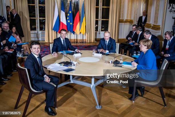 Ukrainian President Volodymyr Zelensky, French President Emmanuel Macron, Russian President Vladimir Putin and German Chancellor Angela Merkel attend...