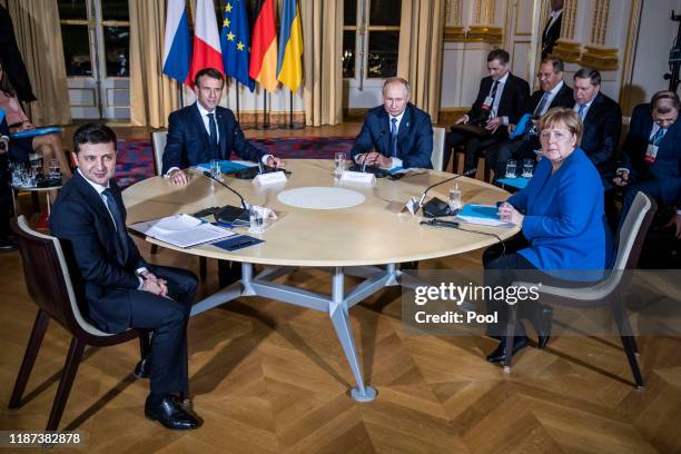 Ukrainian President Volodymyr Zelensky, French President Emmanuel Macron, Russian President Vladimir Putin and German Chancellor Angela Merkel attend...