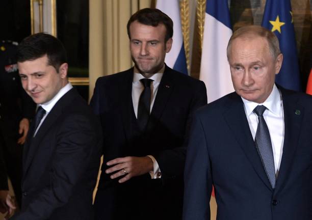 Ukrainian President Volodymyr Zelensky, French President Emmanuel Macron and Russian President Vladimir Putin arrive for a meeting on Ukraine with...