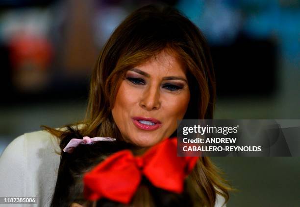 First Lady Melania Trump draws with children during the annual Marine Toys for Tots program hosted by the US Marine Corps Reserve at Joint Base...